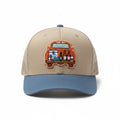 BOX SEAT blue and beige trucker hat featuring an embroidered tailgate scene with a cooler and bottles