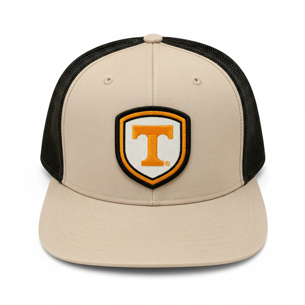 BOX SEAT Richardson 511 khaki and black trucker hat with an orange and white Power T shield patch on the front