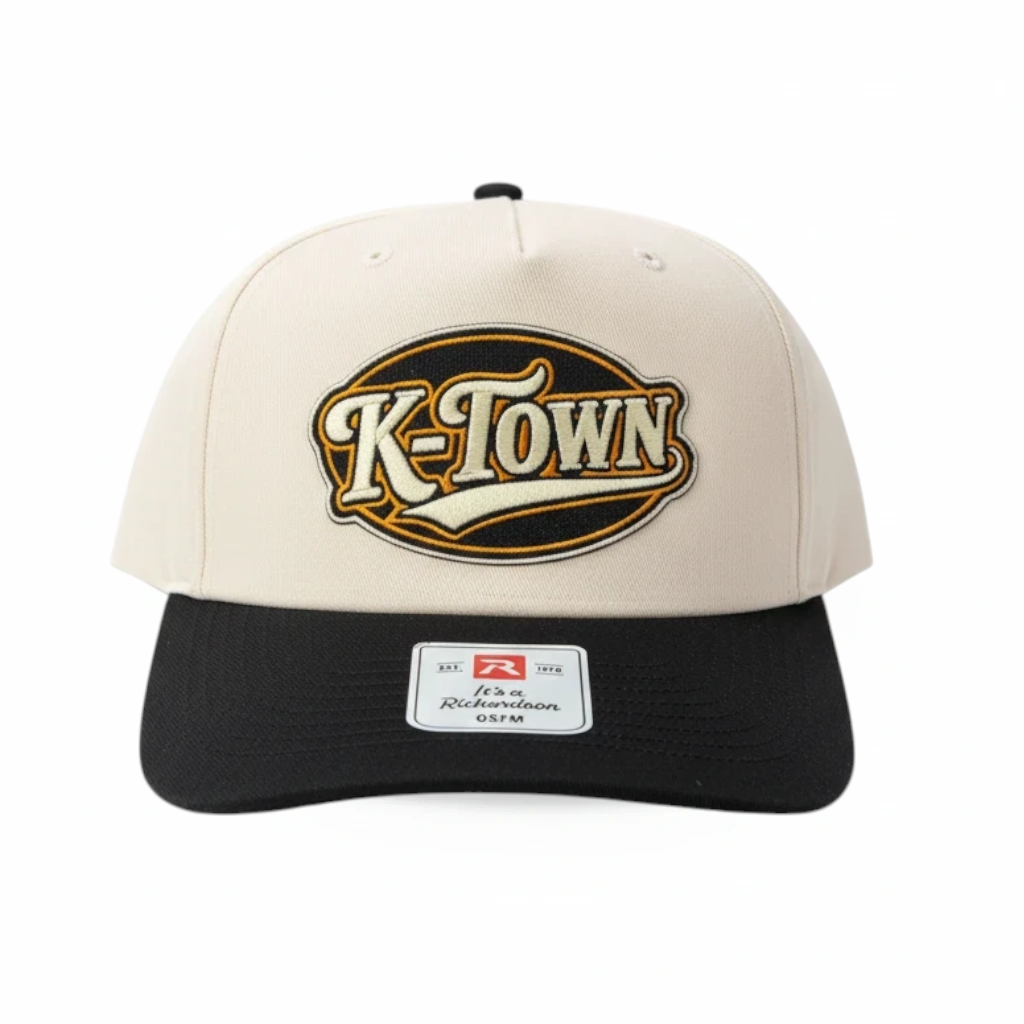 BOX SEAT K-Town Richardson 356 hat featuring a cream crown, black brim, and embroidered oval logo patch