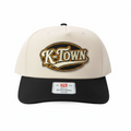 BOX SEAT K-Town Richardson 356 hat featuring a cream crown, black brim, and embroidered oval logo patch