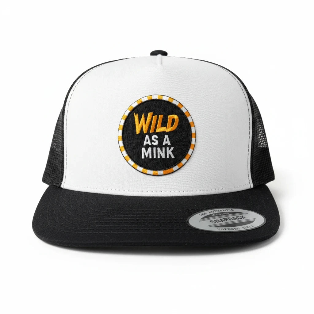 BOX SEAT Wild as a mink trucker hat with a white front panel, black mesh back, and embroidered circular patch.
